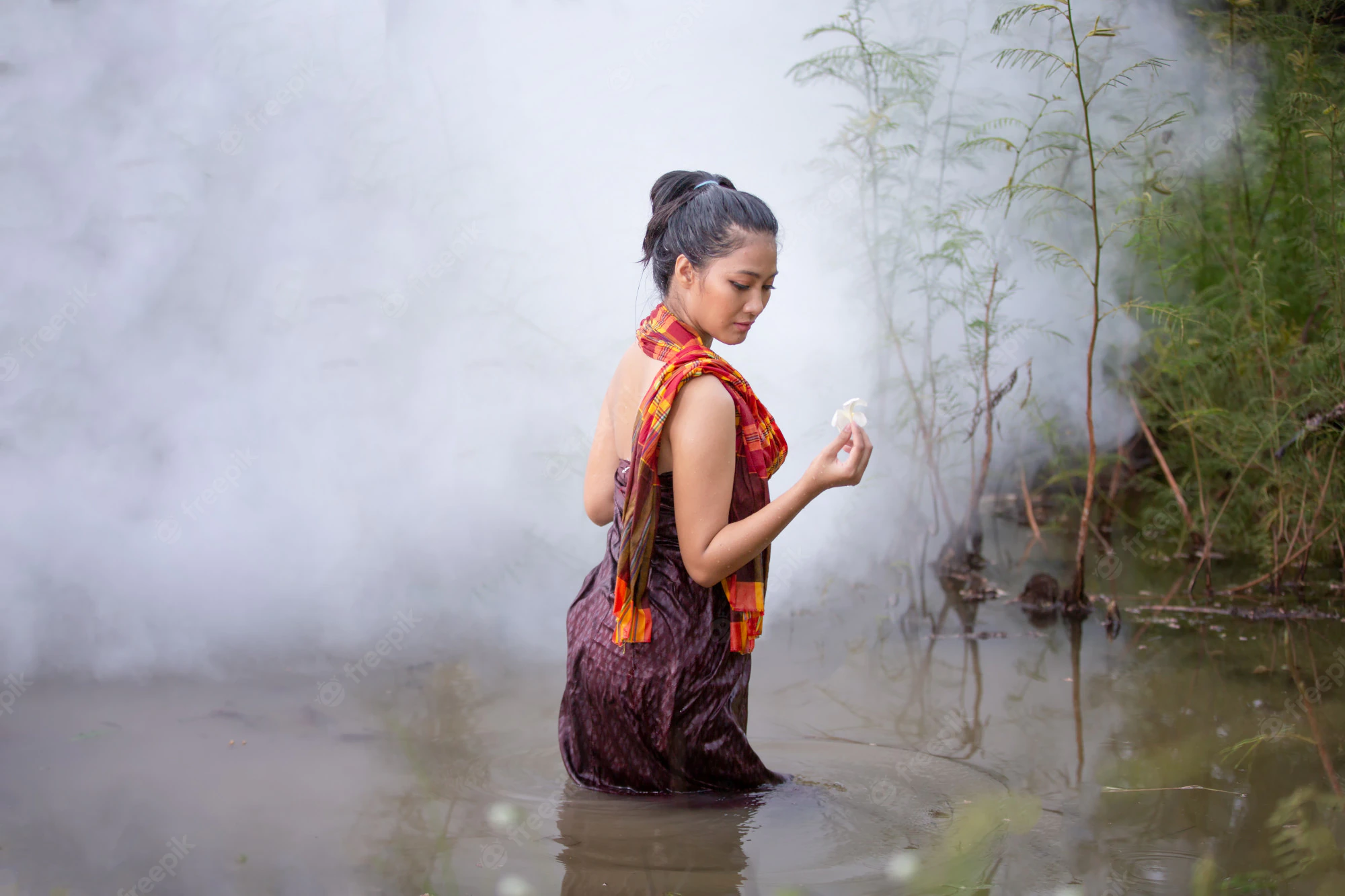 beautiful indian women are bathing in river